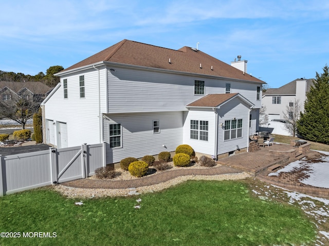 rear view of property featuring a yard