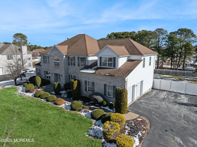 view of front of property featuring a garage and a front lawn