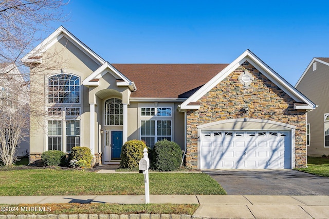 view of front of house featuring a garage and a front lawn