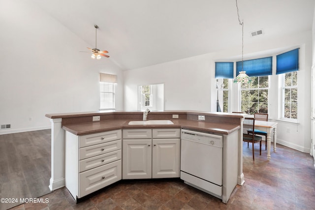 kitchen featuring sink, white cabinetry, vaulted ceiling, a center island with sink, and white dishwasher