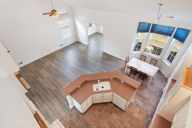 living room with ceiling fan, vaulted ceiling, dark hardwood / wood-style floors, and a healthy amount of sunlight