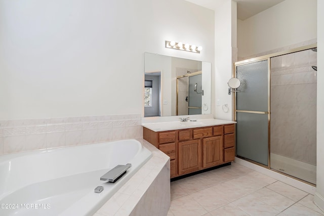 bathroom featuring tile patterned flooring, plus walk in shower, and vanity