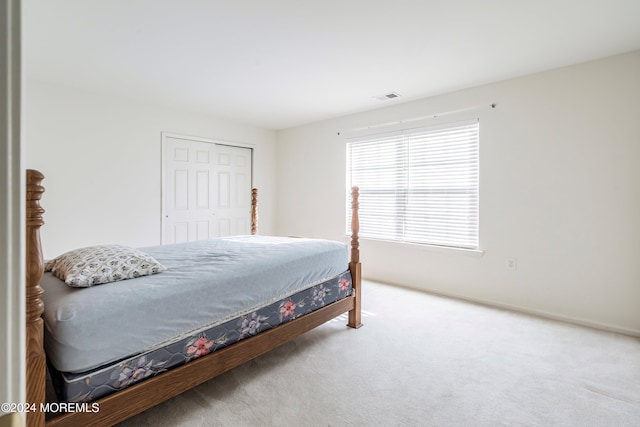 carpeted bedroom with a closet