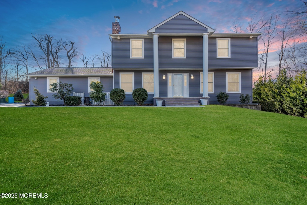 view of front of property with a lawn