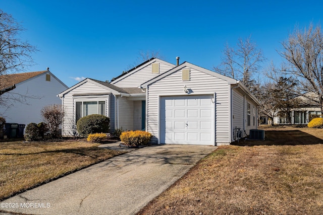 ranch-style home featuring a garage, a front yard, and central air condition unit