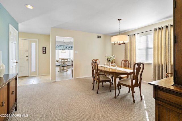 dining area with lofted ceiling and light colored carpet