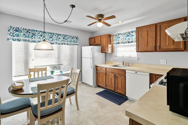 kitchen with sink, white appliances, ceiling fan, range hood, and decorative light fixtures