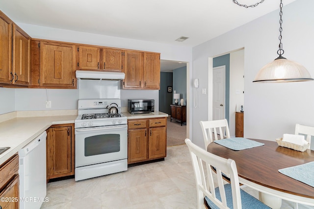 kitchen featuring hanging light fixtures and white appliances