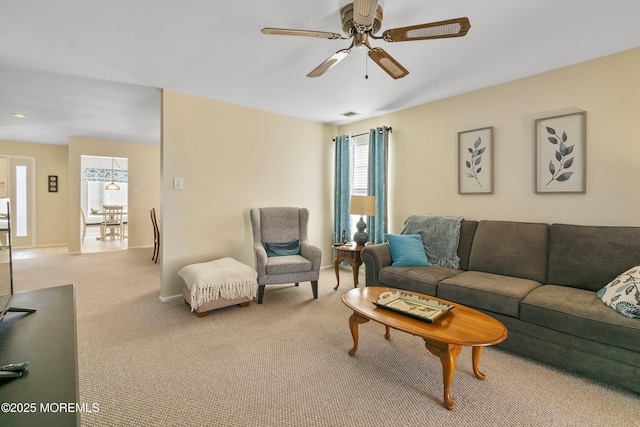 living room featuring light carpet and ceiling fan