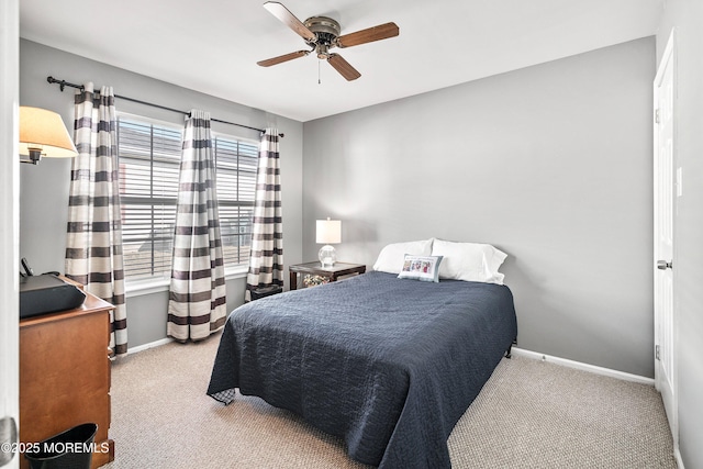 bedroom with ceiling fan and light carpet