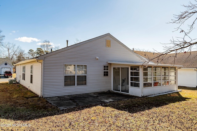 rear view of house featuring a sunroom