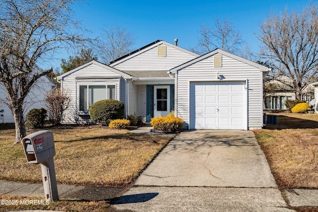 ranch-style house featuring a garage and a front lawn