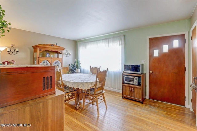 dining area with light hardwood / wood-style floors