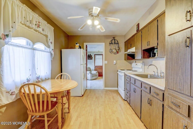 kitchen with ceiling fan, white appliances, light hardwood / wood-style floors, and sink