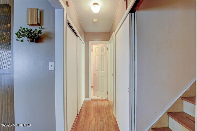 hallway with light hardwood / wood-style floors