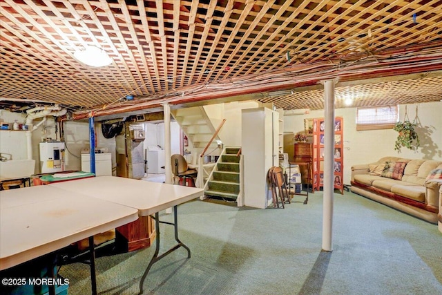 basement with washer / clothes dryer, sink, and water heater