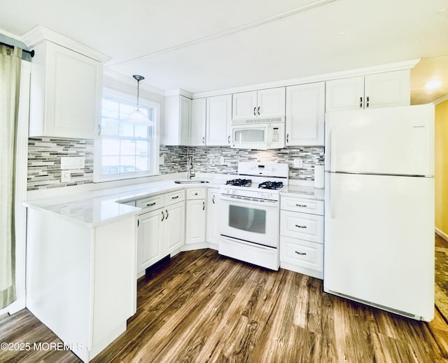 kitchen with dark hardwood / wood-style floors, sink, white cabinets, and white appliances