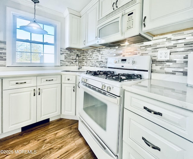 kitchen featuring sink, decorative light fixtures, white appliances, decorative backsplash, and white cabinets