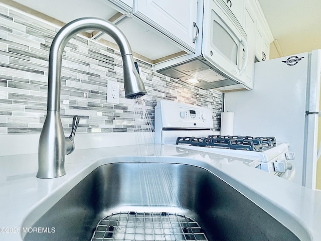 details with tasteful backsplash and white cabinets