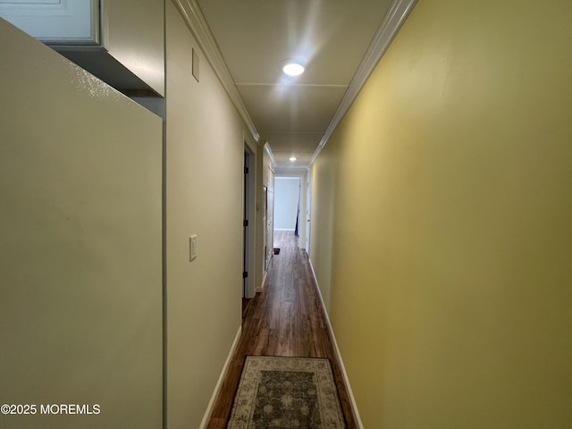 hall featuring dark wood-type flooring and ornamental molding