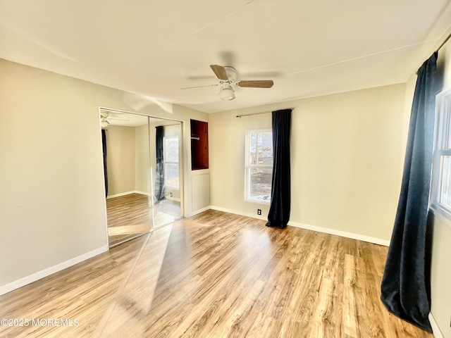 unfurnished room with ceiling fan and light hardwood / wood-style flooring