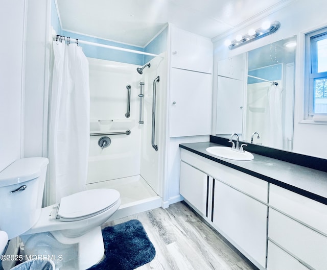 bathroom with wood-type flooring, ornamental molding, vanity, toilet, and a shower with curtain