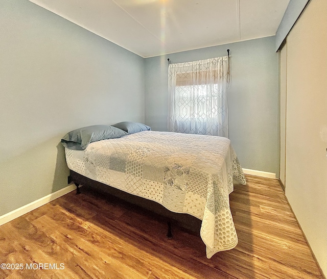 bedroom featuring hardwood / wood-style flooring and a closet