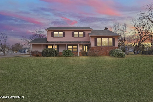 view of front of property with a lawn