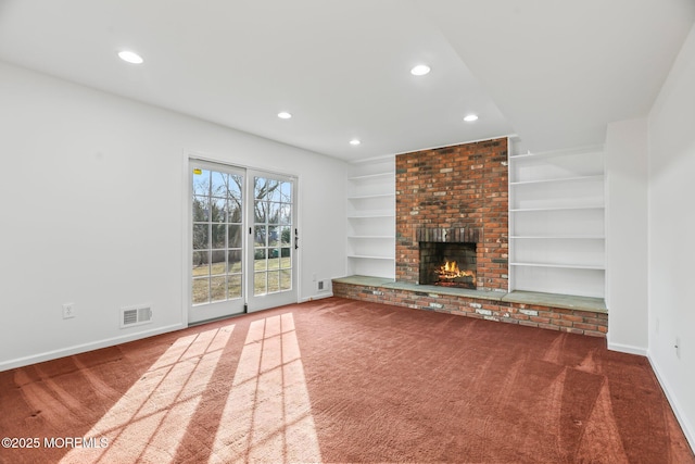 unfurnished living room with a fireplace, built in features, and dark colored carpet