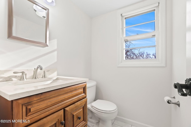 bathroom featuring tile patterned flooring, vanity, and toilet