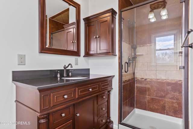 bathroom featuring vanity and a shower with door