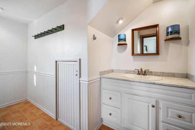 bathroom with vanity and lofted ceiling