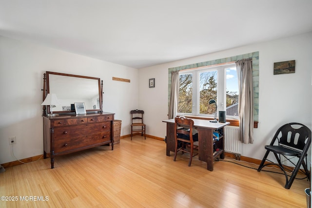 interior space featuring radiator and light hardwood / wood-style floors