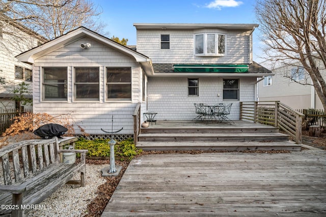 back of property with a wooden deck