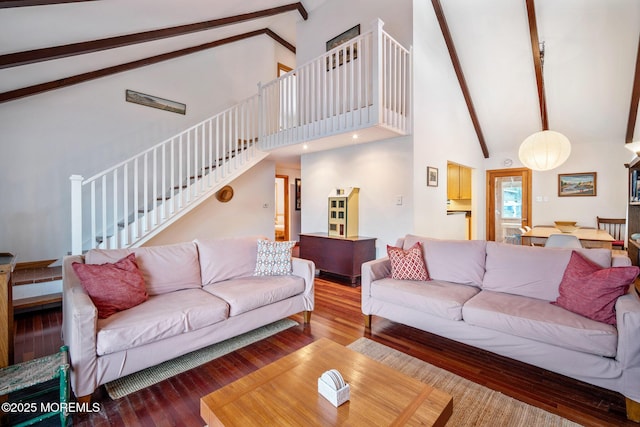 living room with beam ceiling, wood-type flooring, and high vaulted ceiling