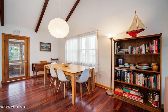 dining area with a healthy amount of sunlight, dark hardwood / wood-style floors, and beam ceiling