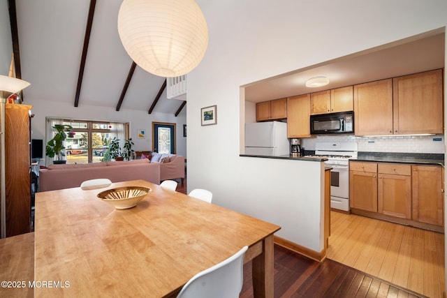 dining area with beamed ceiling, high vaulted ceiling, and hardwood / wood-style floors