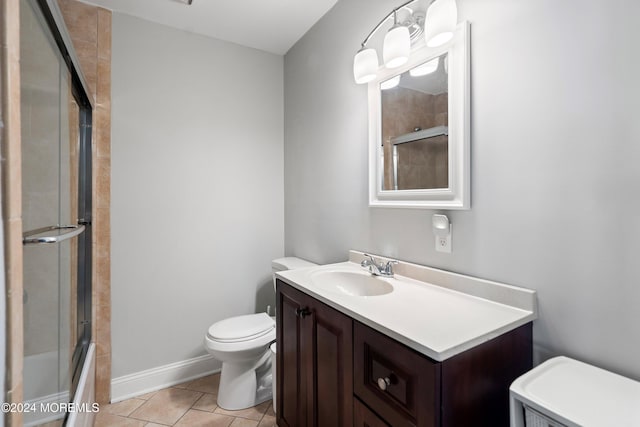 full bathroom with vanity, tile patterned flooring, bath / shower combo with glass door, and toilet