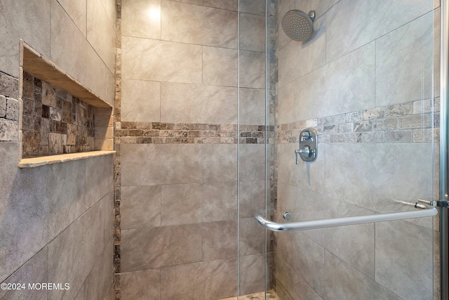 bathroom with a shower with shower door