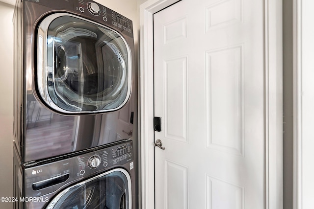 laundry room with stacked washing maching and dryer