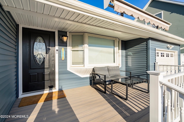 doorway to property with a garage and covered porch