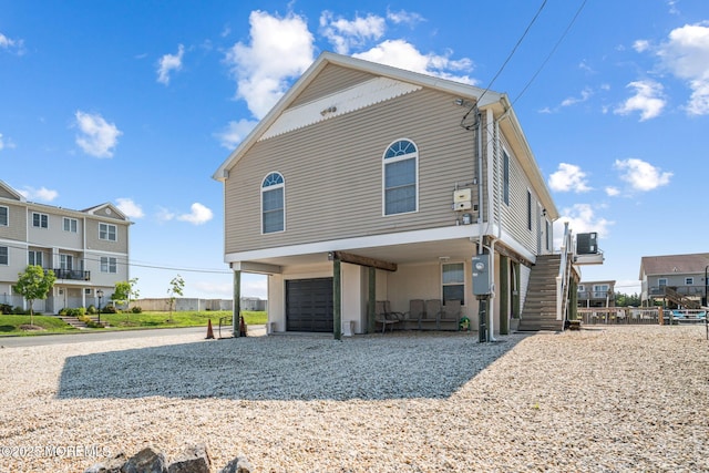 view of front facade with a garage and central AC unit