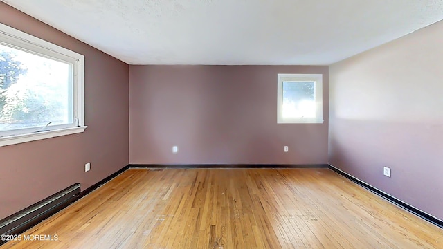 spare room featuring light hardwood / wood-style floors and baseboard heating