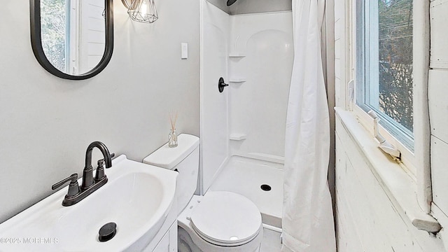 bathroom with sink, toilet, and a shower with shower curtain