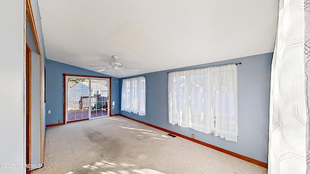 empty room with light carpet, vaulted ceiling, and ceiling fan