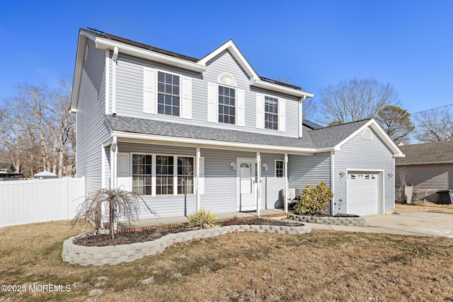 view of property with a porch, a garage, and a front lawn