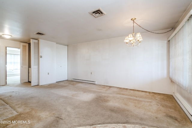 empty room with a baseboard radiator, a chandelier, and carpet flooring