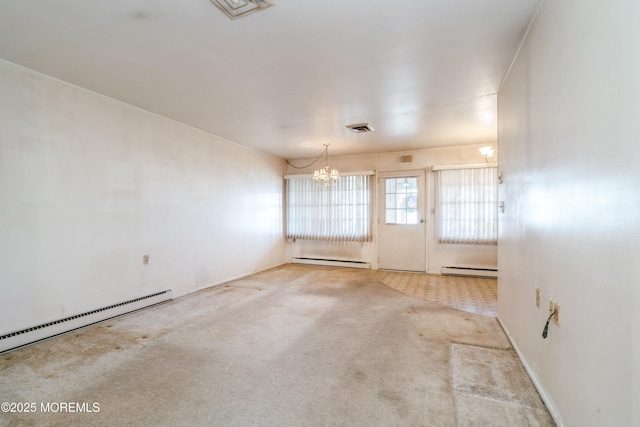 carpeted spare room with baseboard heating and a chandelier