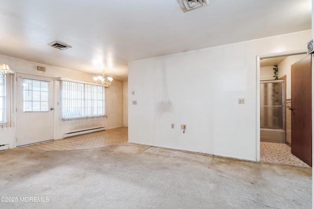 carpeted spare room with an inviting chandelier and a baseboard heating unit