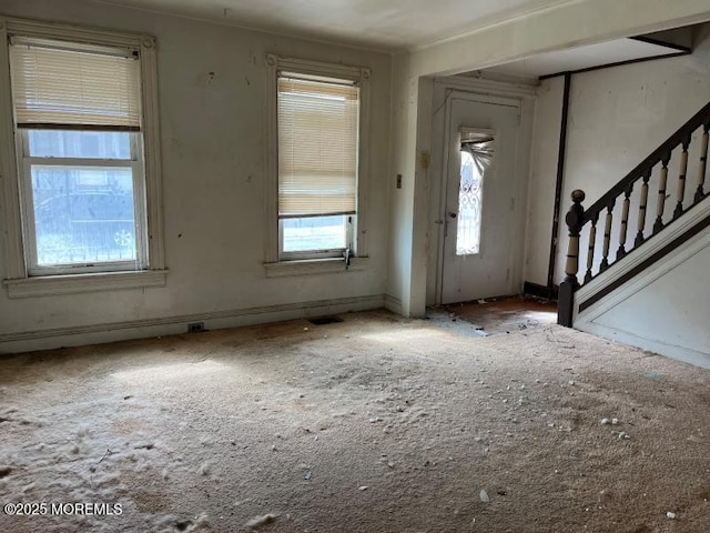 entryway featuring stairs, visible vents, and baseboards